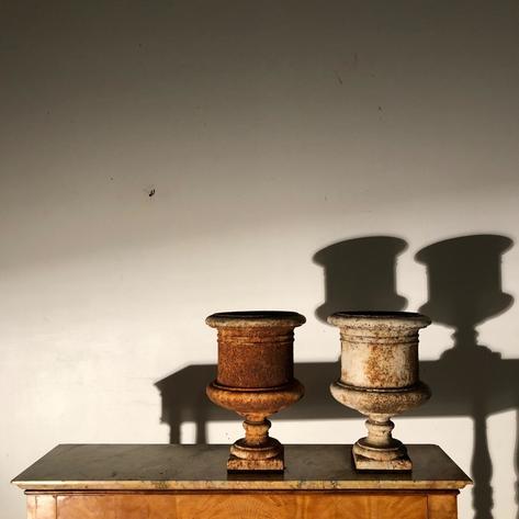 Pair of cast iron urns